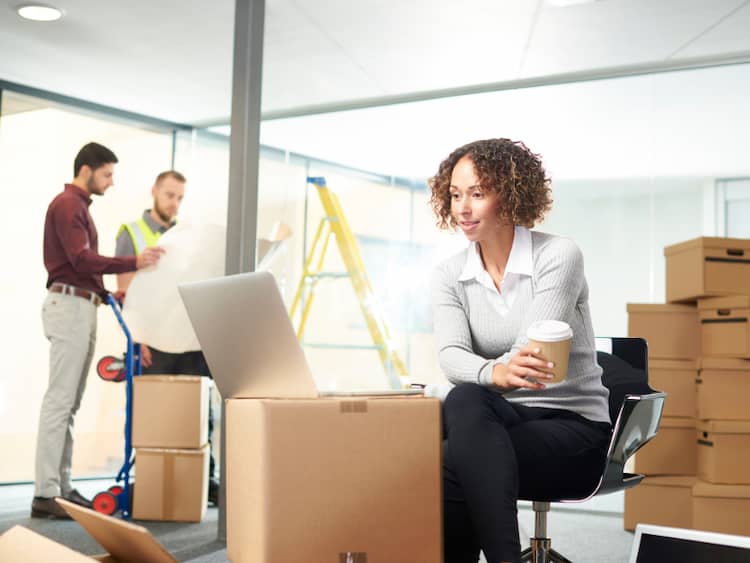 Employee relocation company helping employee move her boxes